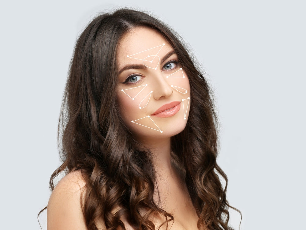 Woman with marked facial areas for skin booster treatment at Elite Med Spa