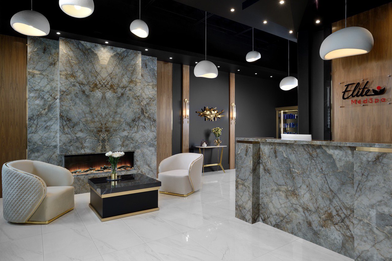 Modern luxury reception area at Elite Med Spa featuring marble decor and elegant lounge chairs